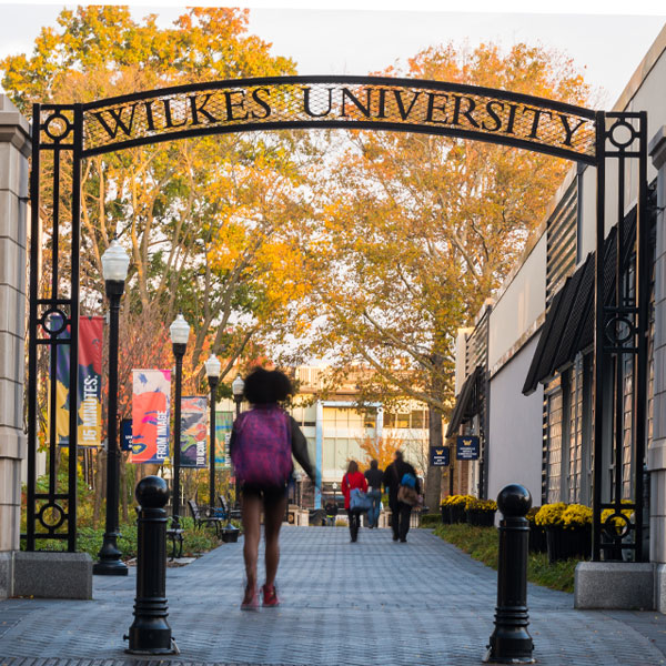 Students walking through gateway on campus